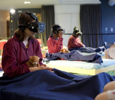 Three students wearing interactive gaming masks