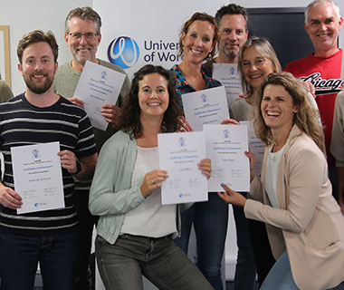 A group of lecturers are holding certificates