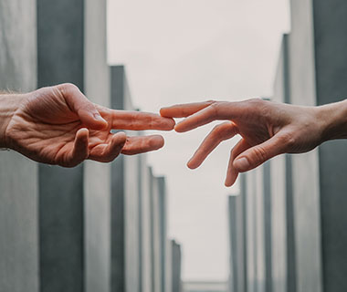 two hands are reaching out to each other