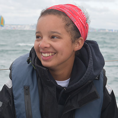 Young woman on a boat in a red headscarf