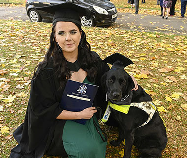 Maisy McAdam pictured on Graduation with guide dog