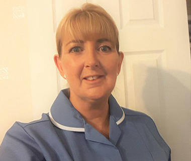 Portrait of a mature woman in a blue nurses uniform
