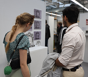 two students looking at artwork