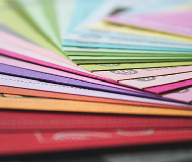 Several brightly coloured folders on a table