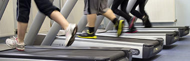 Four pairs of legs on four separate running machines