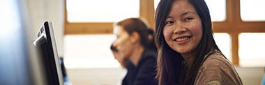 Smiling girl at a computer