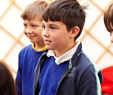 Three male schoolchildren in blue uniform