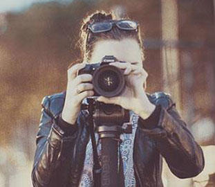 A girl is taking a photograph