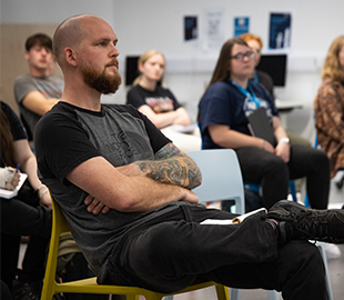 man sat in a chair in a lecture