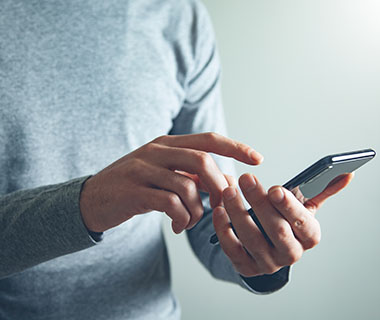 Two hands are holding a mobile phone