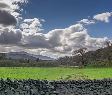 Rolling hills still behind a dry stone wall in the countryside