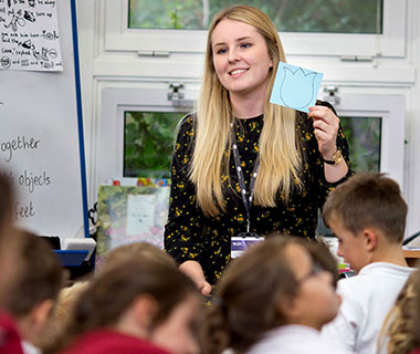 A female student at the front of a primary school classroom