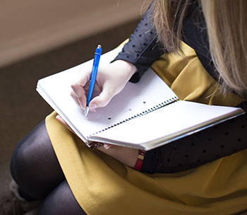 student writing in a book