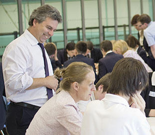 Lecturer standing beside students