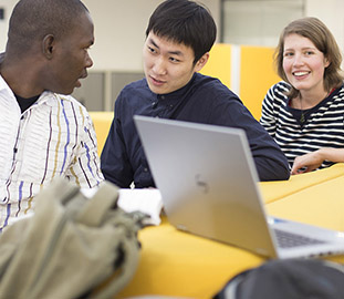 three students at a desk